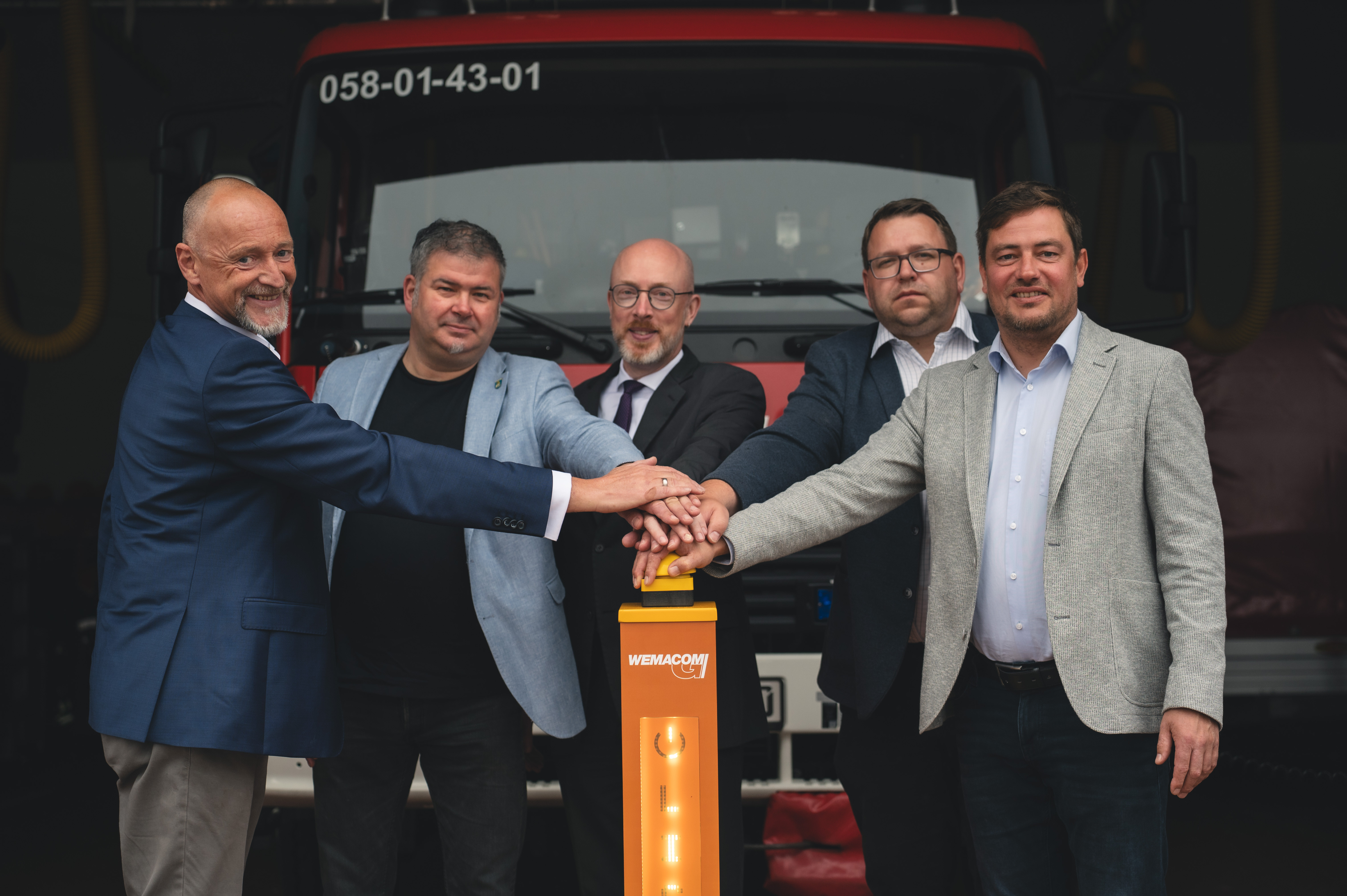 Symbolisches Drücken des Buzzers aller Beteiligten Herren vor der Feuerwehr in Kröpelin, als Startschuss und gleichzeitigen Abschluss für das schnelle Internet im Landkreis Rostock